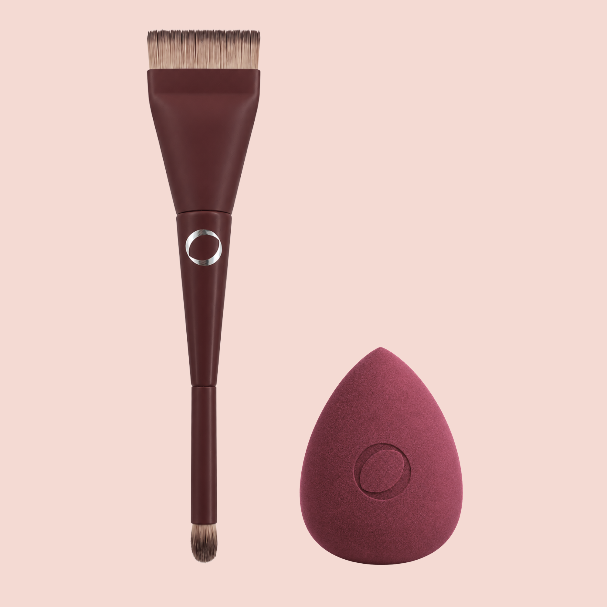 A Aspilon Cosmetics makeup brush with a dark burgundy handle and angled bristles, shown next to the Aspilon Cosmetics matching teardrop-shaped sponge made for CC cream and foundation.