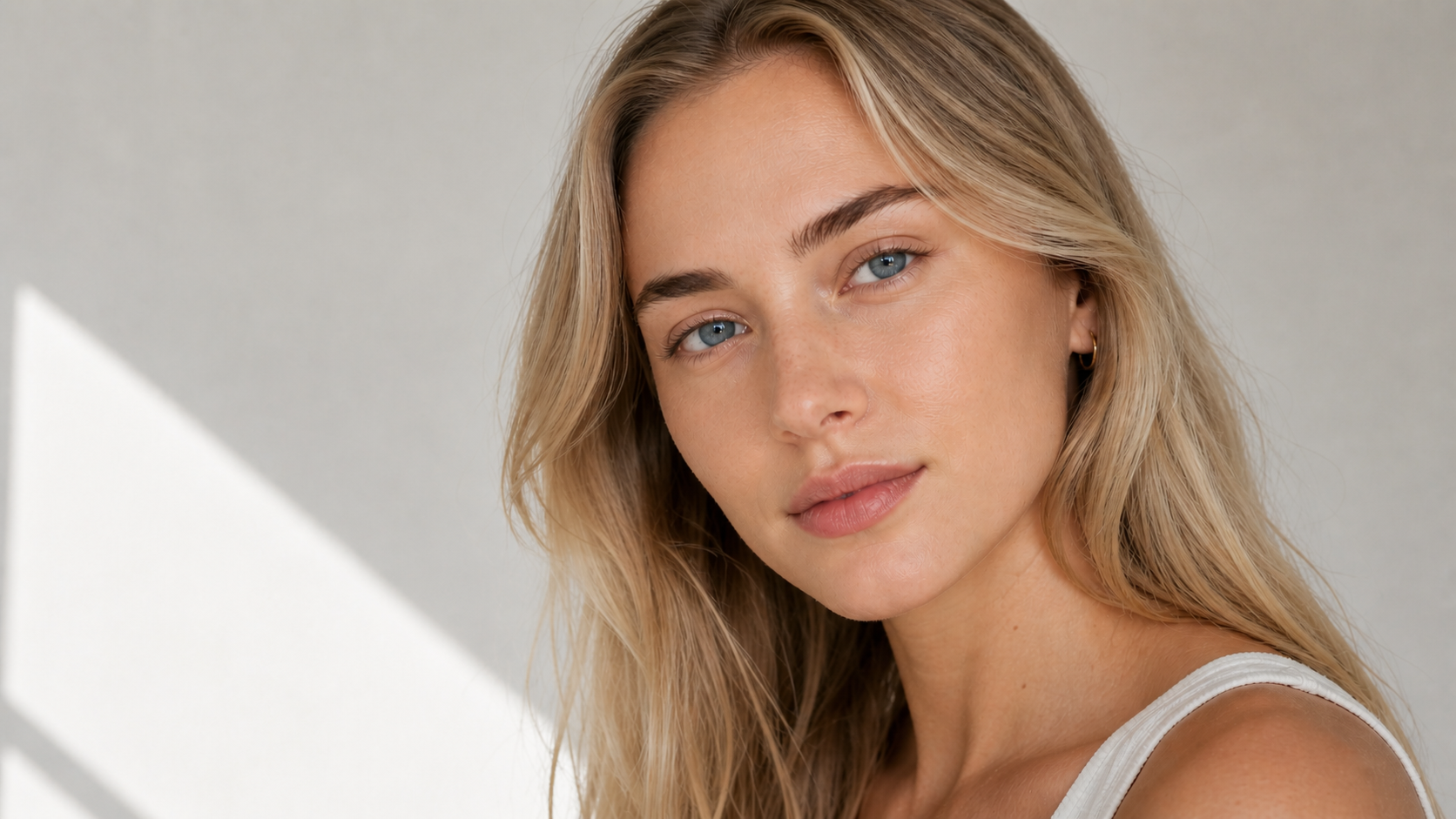 Aspilon model after makeup application, showing buildable coverage